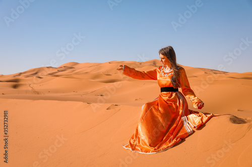 A girl in a beautiful Moroccan dress. Merzouga Morocco. photo