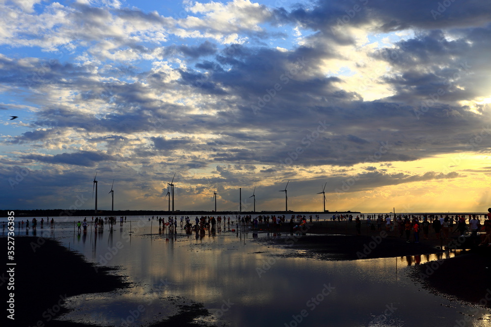 Gaomei wetlands during sunset with wind turbine background in Taiwan Taichung,