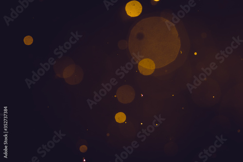 Fototapeta Naklejka Na Ścianę i Meble -  Dark Abstract Gold bokeh sparkle on black background