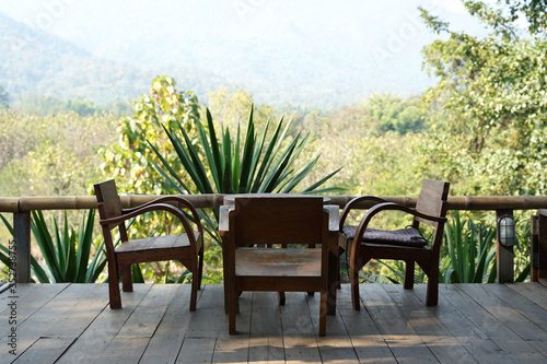 Solid teak timber lounge chair set with mountain background