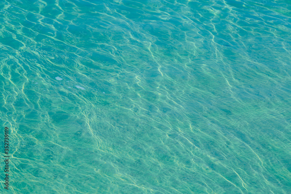 Fototapeta premium Blue pool water with sun reflections