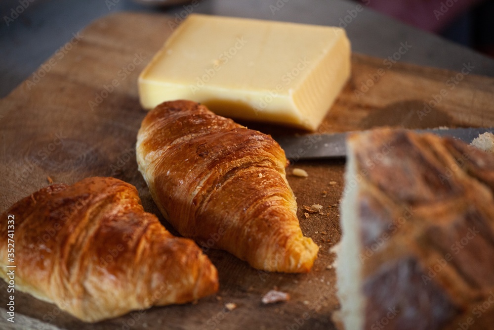 croissants and cheese on cuttingboard croissants and cheese on cuttingboard