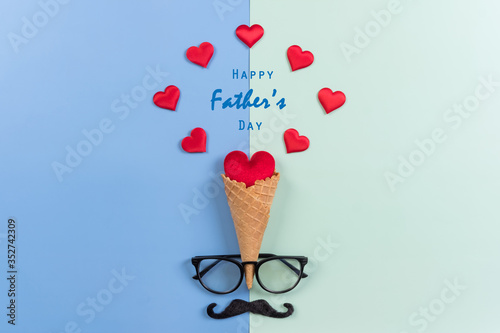 Happy Fathers Day background concept.Decorated ice cream cone, red heart, mustache, eyeglasses on bright pastel background with copy space. Top view, flat lay.