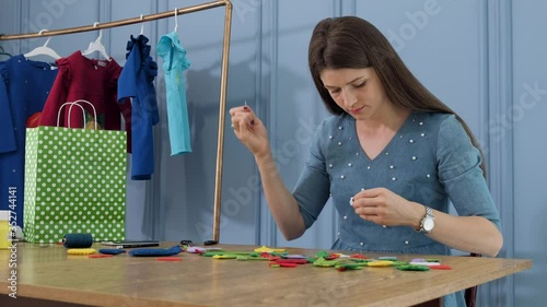 Designer makes, sews soft childrens toys from fabric. In the form of fruits