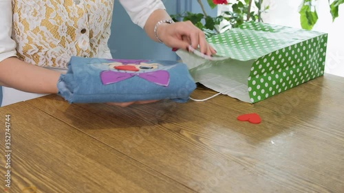 Woman packs a handmade dress and sends it to the client