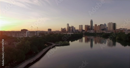 The morning Austin skyline over a calm Lady Bird Lake and empty Hike and Bike Trail boardwalk during the covid coronavirus pandemic photo