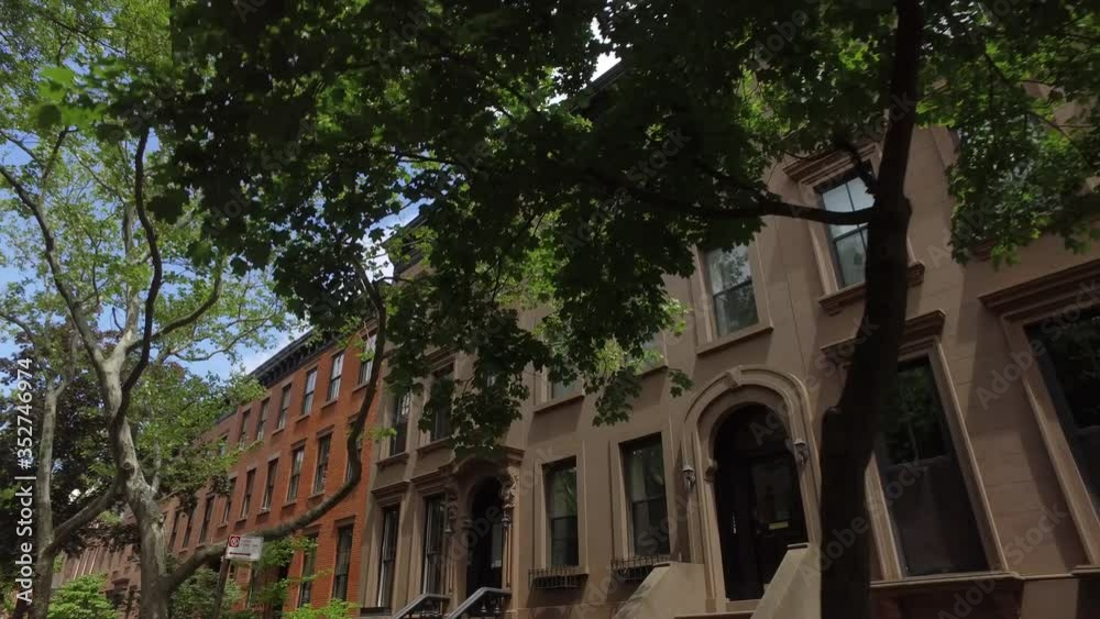 POV shot driving past brownstones on Tomkins Pl. in Cobble Hill Brooklyn