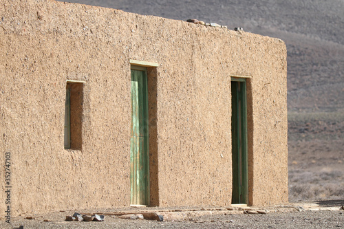 Abandoned and derelict mud and straw brick farmhouse in Tankwa Karoo Park South Africa photo