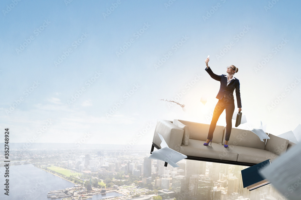 Businesswoman standing against landscape and making selfie Businesswoman standing against landscape and making selfie