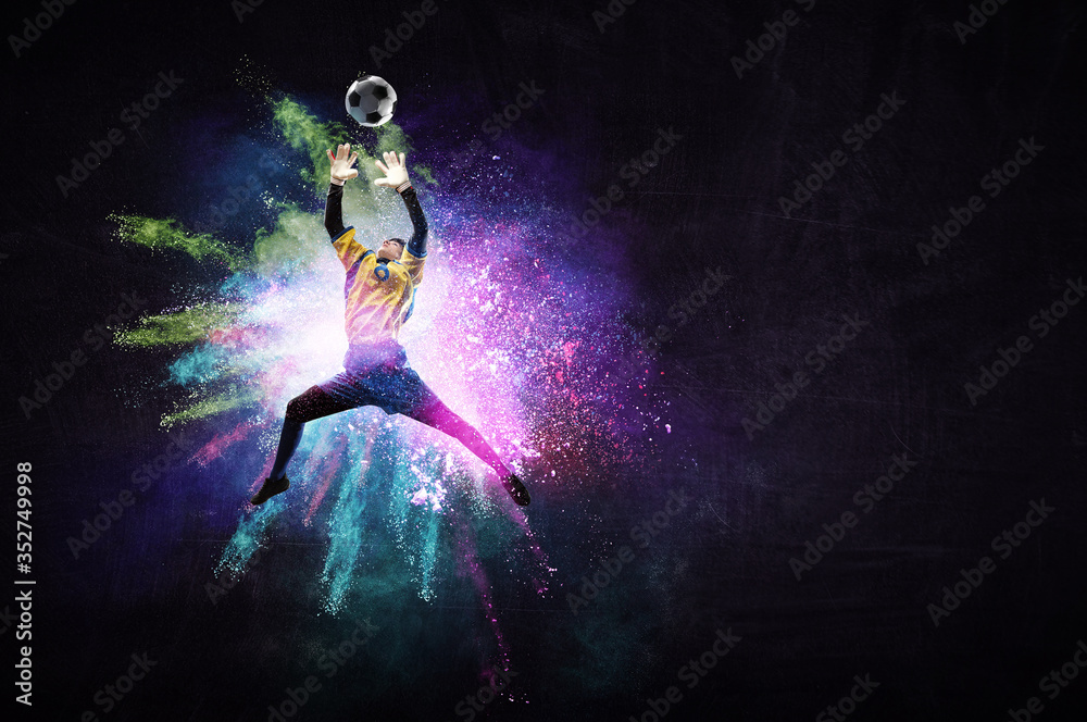 Boy playing soccer hitting the ball