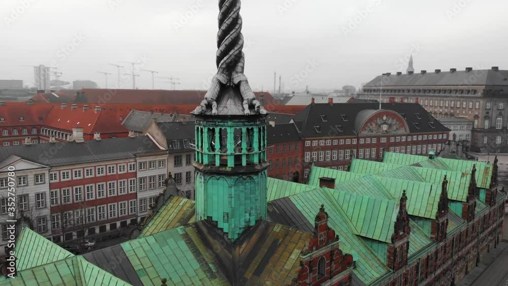 Orbit around tower of The Old Stock Exchange (Børsen) on a cloudy day, Copenhagen, Denmark-4K