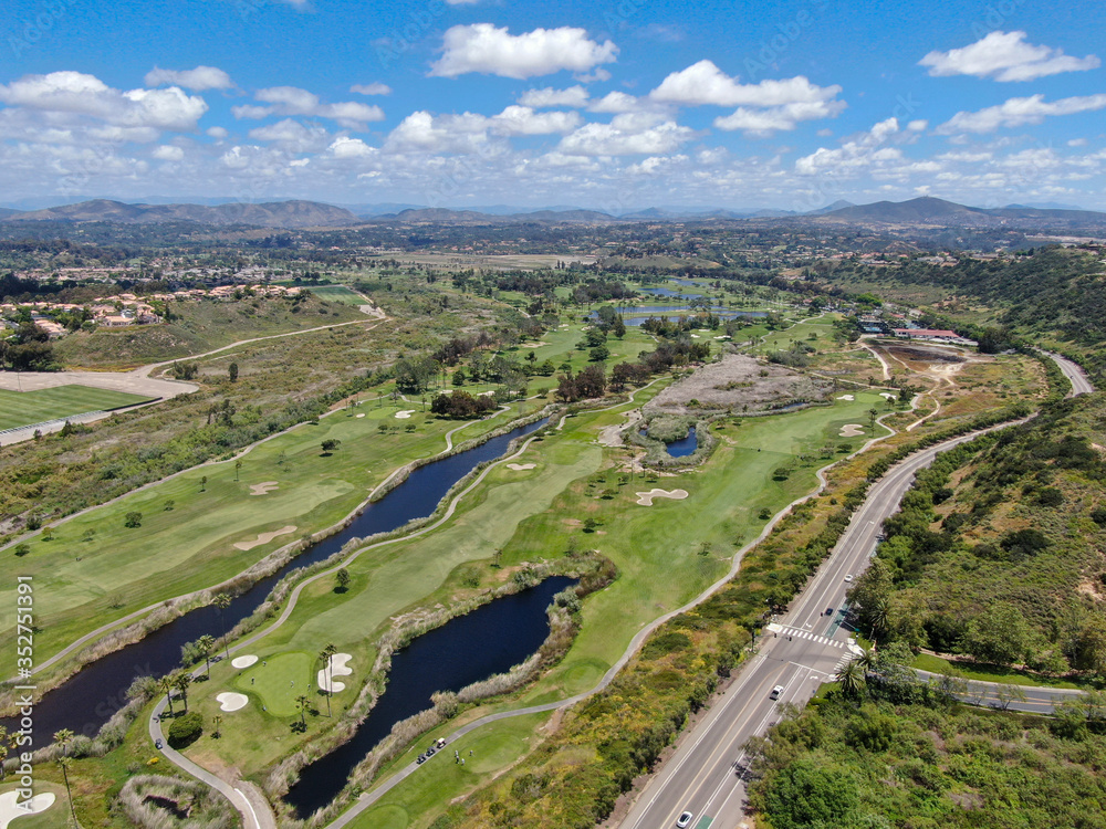 Aerial view of a green golf course during sunny day in South California. USA