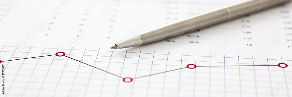 Financial statistics documents on clipboard pad at office table closeup Financial statistics documents on clipboard pad at office table closeup