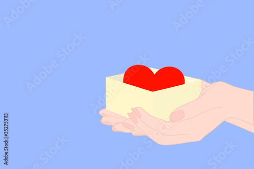 hand is holding the yellow gift box that has the red heart inside. Encourage other person. Giving brave. charity or donate to children or poor person. hospital, medical concept. Valentine day. 