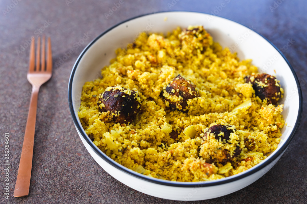 plant-based food, vegan turmeric couscous with falafels onions and chopped tomatoes plant-based food, vegan turmeric couscous with falafels onions and chopped tomatoes