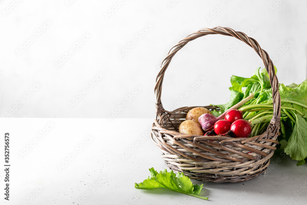 fresh garden vegetables in a basket on a light background, place for text fresh garden vegetables in a basket on a light background, place for text