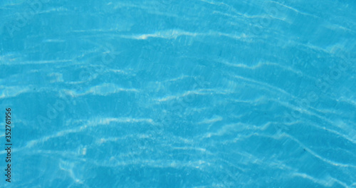 Swimming pool water texture in blue color © leungchopan