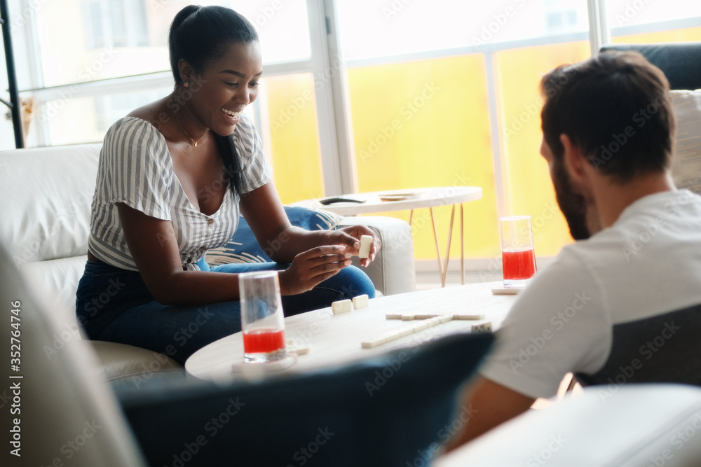 Happy Interracial Couple Having Fun Playing Domino At Home