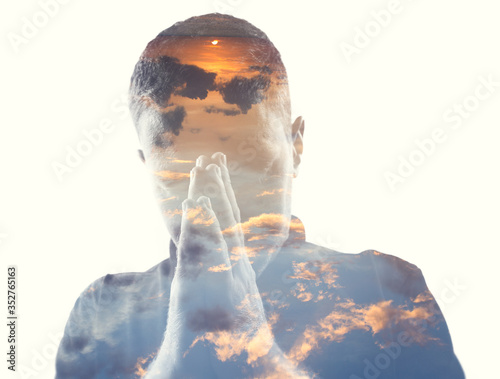 Double exposure of man in the clouds at sunrise or sunset time photo