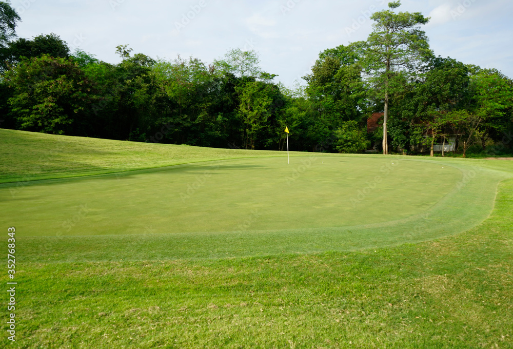 Beautiful golf course in a sunny day. Background evening golf course has sunlight shining down. Golf course in the countryside. Beautiful golf course in a sunny day. Background evening golf course has sunlight shining down. Golf course in the countryside.