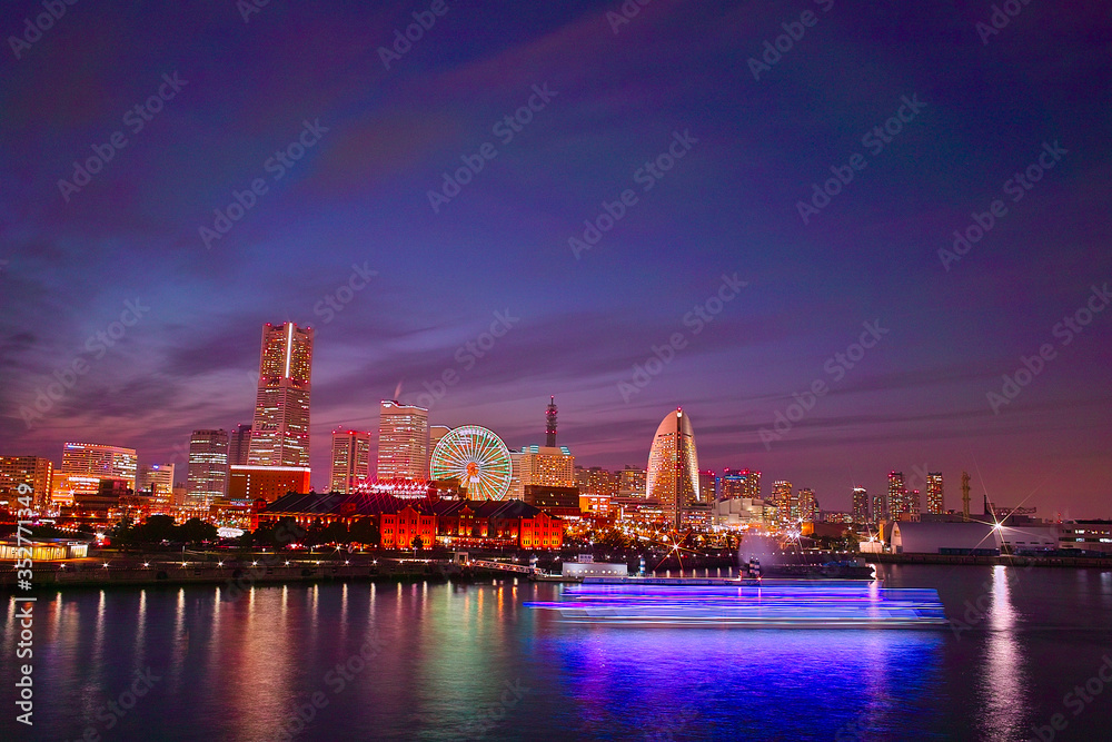 The skyline view of Yokohama harbour at night. Yokohama Port serves 38000 ships a year.