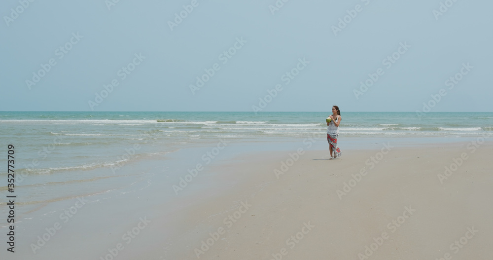 Woman walk in the beach