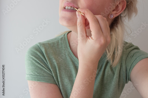  Girl brushes her teeth with a toothpick after eating photo