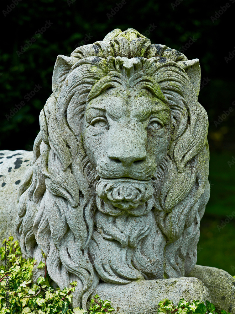 Head of the magestic stone lion in the garden at a French Manor House