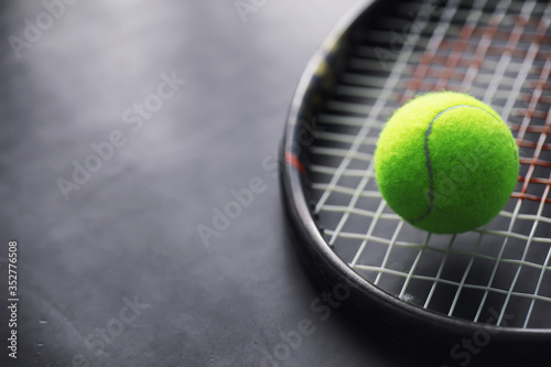 Sport and healthy lifestyle. Tennis. Yellow ball for tennis and a racket on the table. Sports background with tennis concept.
