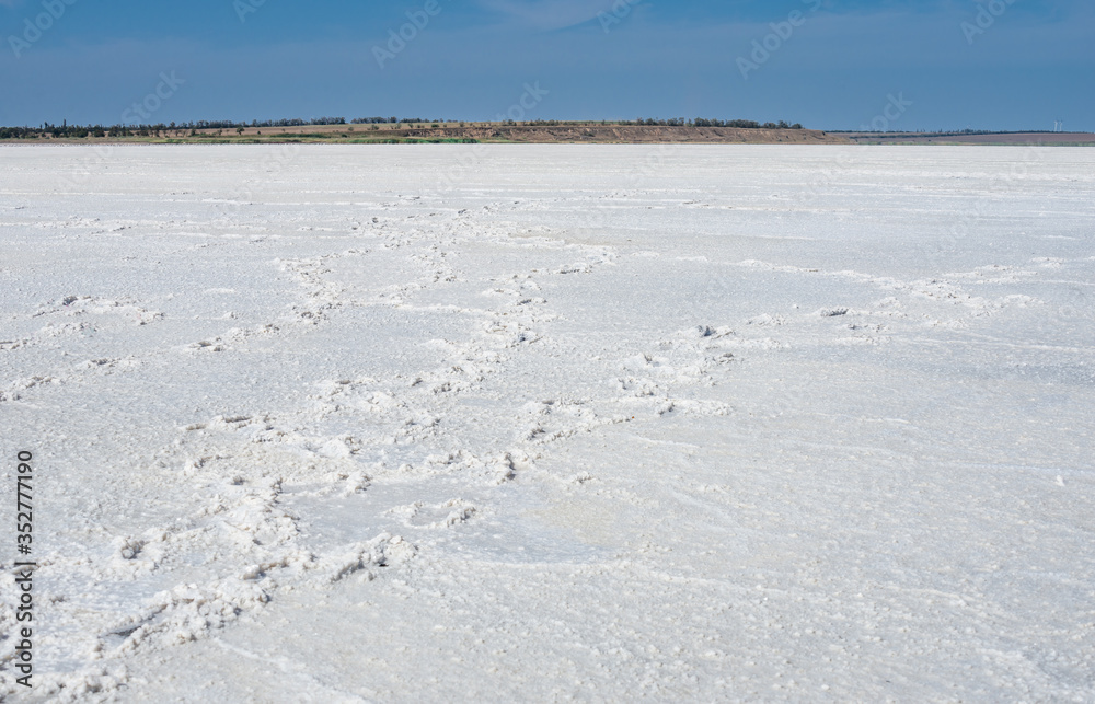 Dried salt lake under the blue sky. Dried salt lake under the blue sky.