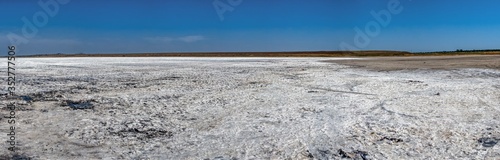 Dried salt lake under the blue sky.