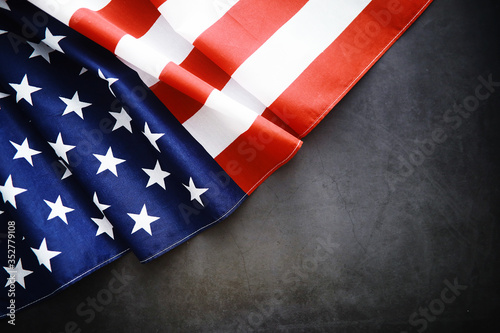 Flapping flag USA with wave. American flag for Memorial Day or 4th of July. Closeup of American flag dark background
