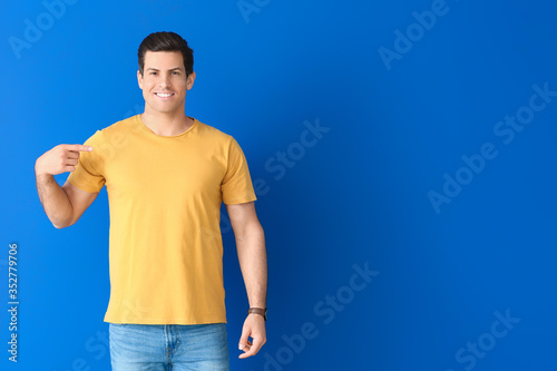 Man in stylish t-shirt on color background