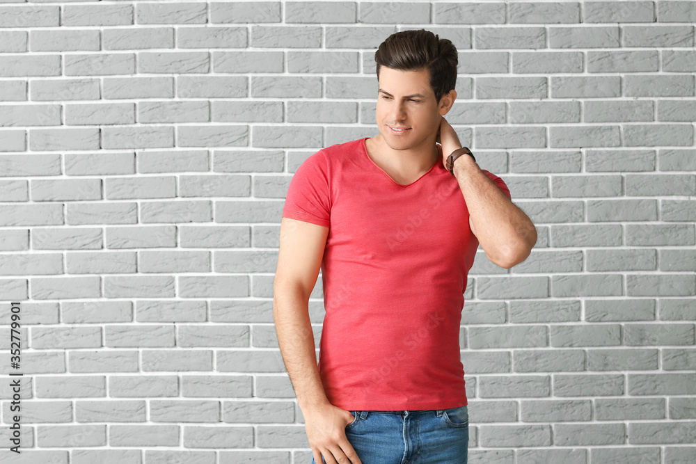 Man in stylish t-shirt on brick background Man in stylish t-shirt on brick background