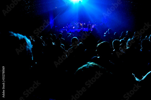 People watching a concert in a hall or club