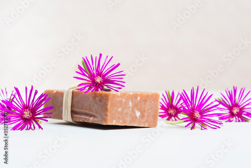 Handmade craft soap block and magenta flowers