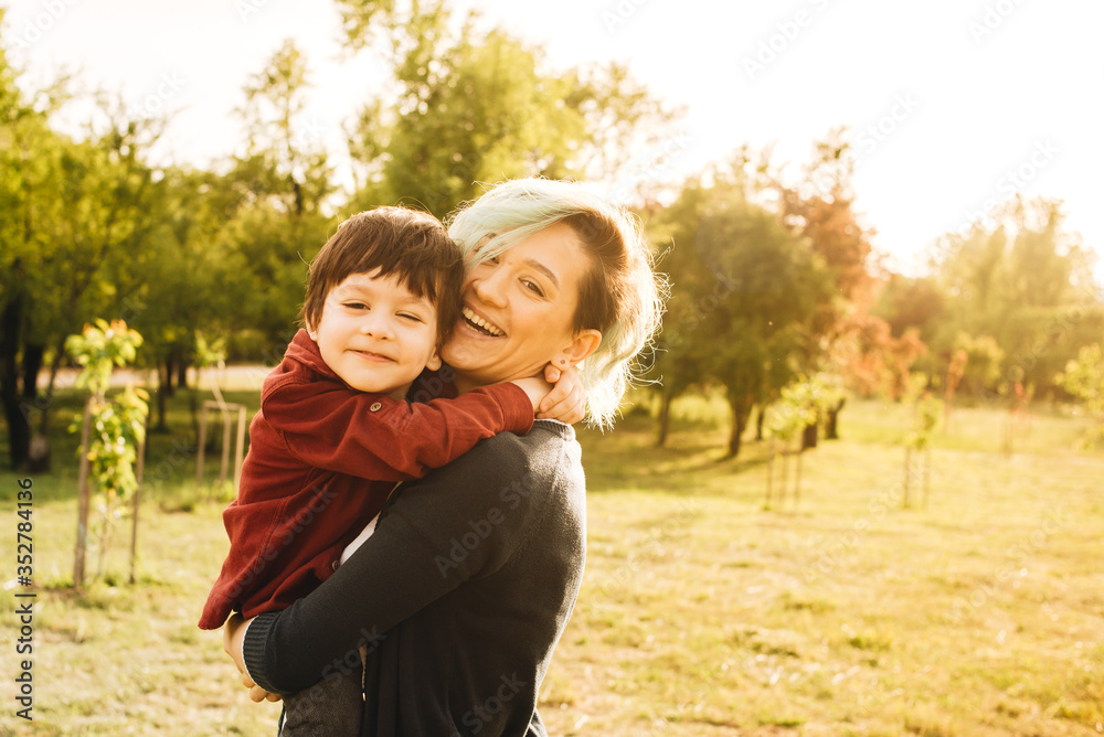 Happy young mother playing and having fun with her little baby son on sunshine. Happy family concept Happy young mother playing and having fun with her little baby son on sunshine. Happy family concept