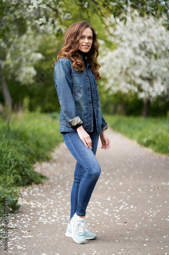 Happy smiling retty girl is standing in the garden