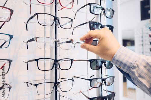 Choosing glasses in a eyewear store © JAVIER LARRAONDO