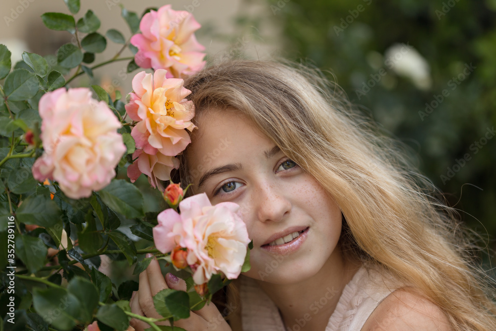 Fototapeta premium Summer concept. Smiling teenager girl posing with pink and orang