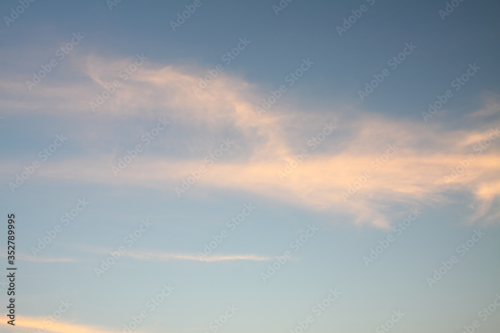 Beautiful blue sky with white and pink cloud. Dawn. Idyllic morning. Wallpaper and background.