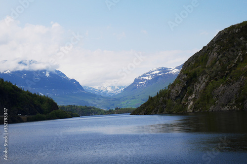 Fototapeta Naklejka Na Ścianę i Meble -  Norwegian fjord with mountains in background, Hardangerfjord 