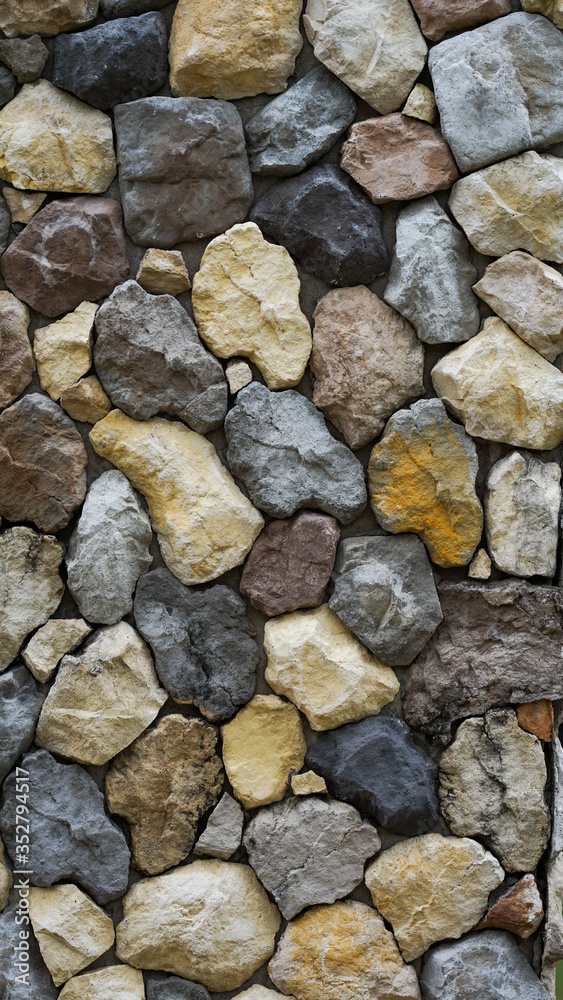 The walls made of many small stones were arranged artistically. Suitable for use as background images.