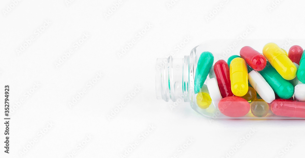 Colorful pills and tablets in plastic bottle on white background Colorful pills and tablets in plastic bottle on white background