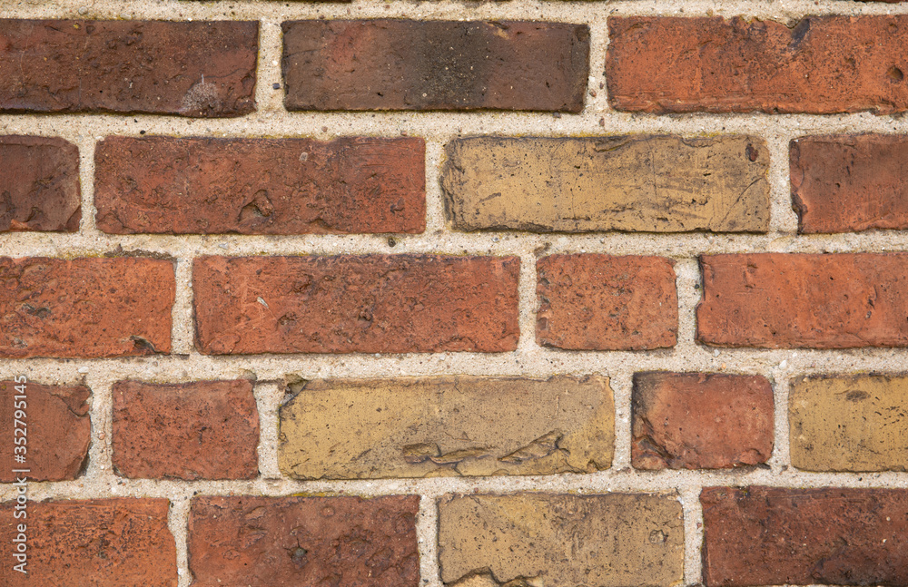 Old brick wall with many different colors of bricks as a background Old brick wall with many different colors of bricks as a background