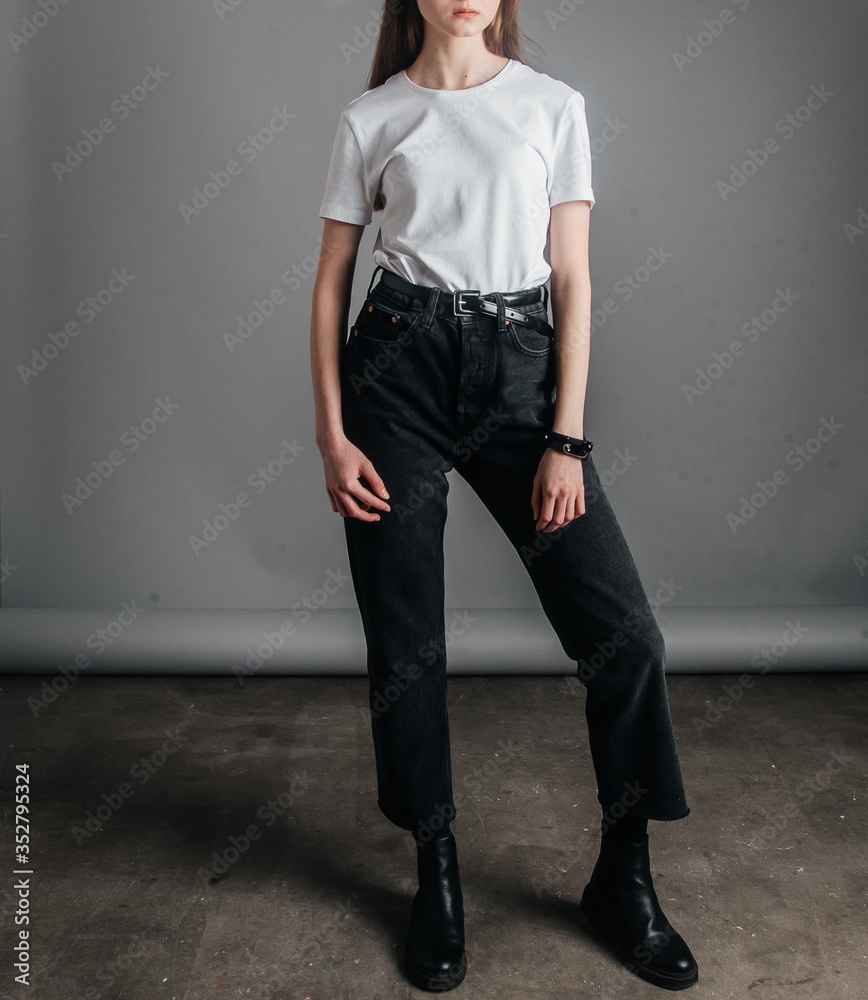 Young Attractive Hipster Woman in Stylish Sunglasses in a White Polo T-shirt  in Black Jeans Walking in Downtown at Sunset. Stock Photo - Image of  design, fashionable: 137671104