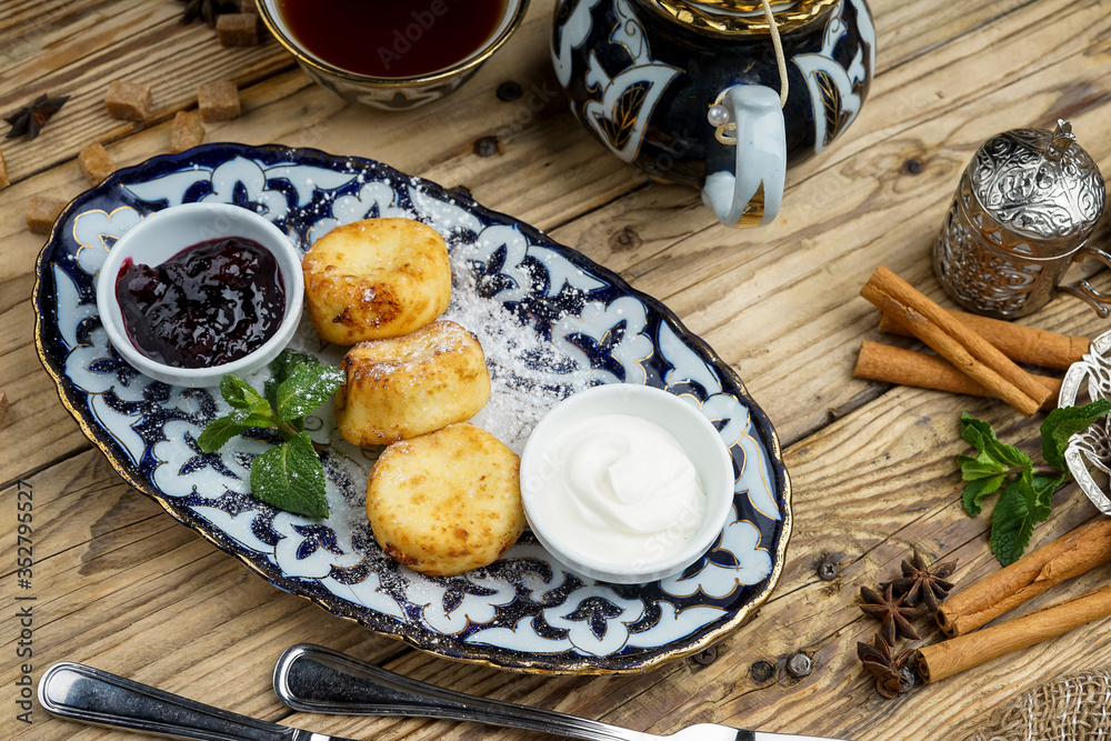 Pancakes on plate for breakfast with jam and spoon 