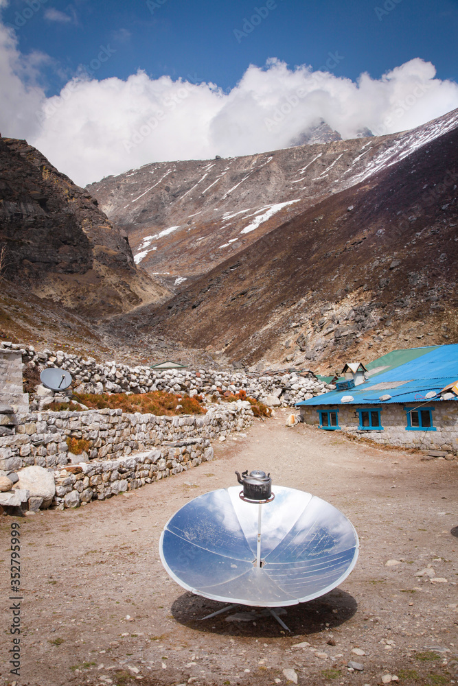 Foto de Warming the teapot in a solar cooker. Ecology concept