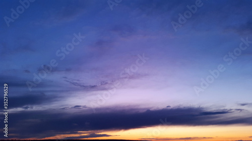 dark blue and violet sky with orange sunset at evening