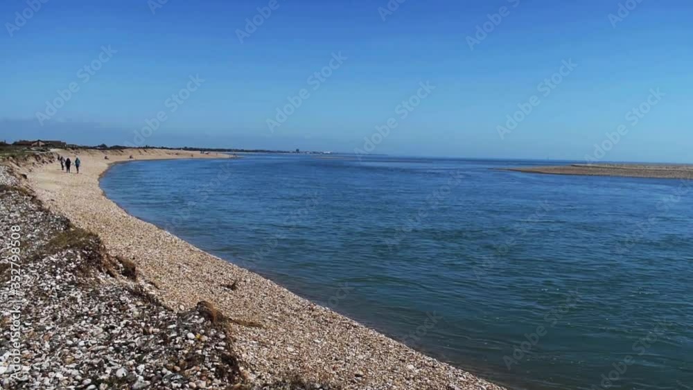 Pagham entrance to harbour and beautiful coastline on a warm and sunny springtime day. Pagham entrance to harbour and beautiful coastline on a warm and sunny springtime day.